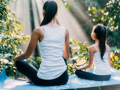 mother and child sitting up straight doing yoga