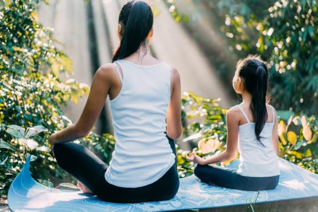mother and child sitting up straight doing yoga