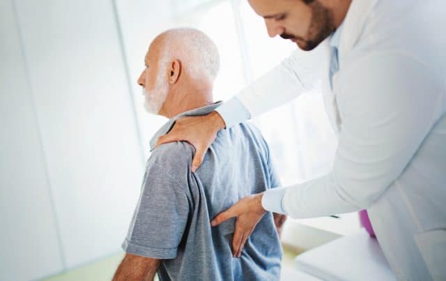 older man with back pain