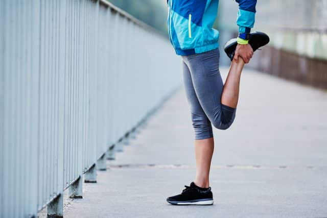 woman stretching before running