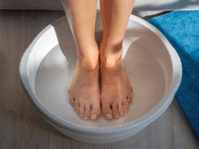 Woman-made-bath-with-hot-water-and-baking-soda-for-his-feet.