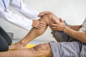 Man’s knee during physical therapy after partial knee replacement in NY